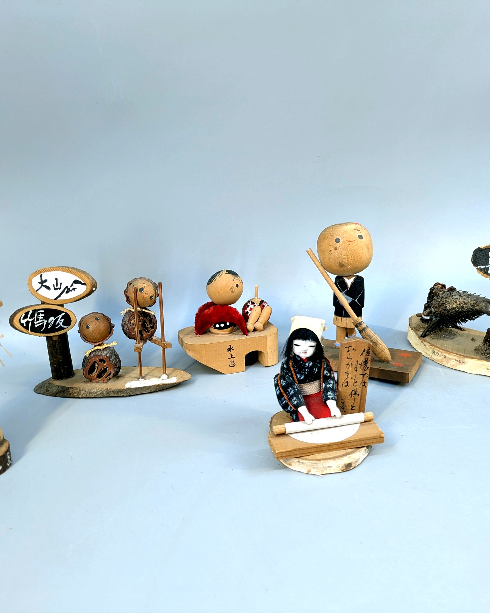 Vintage Japanese miniature village figures on a wooden table