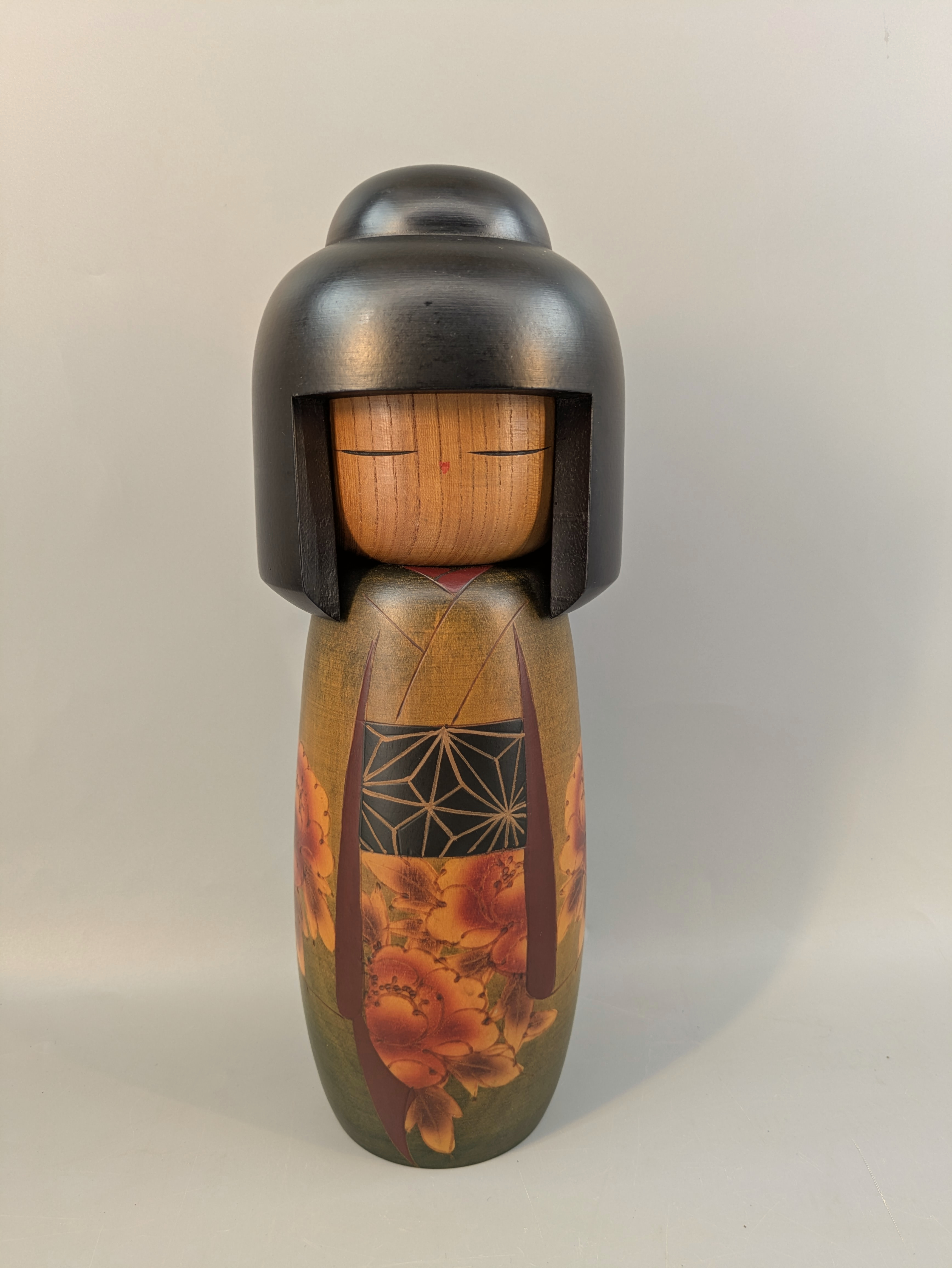 Large painted Japanese wooden doll with floral decoration