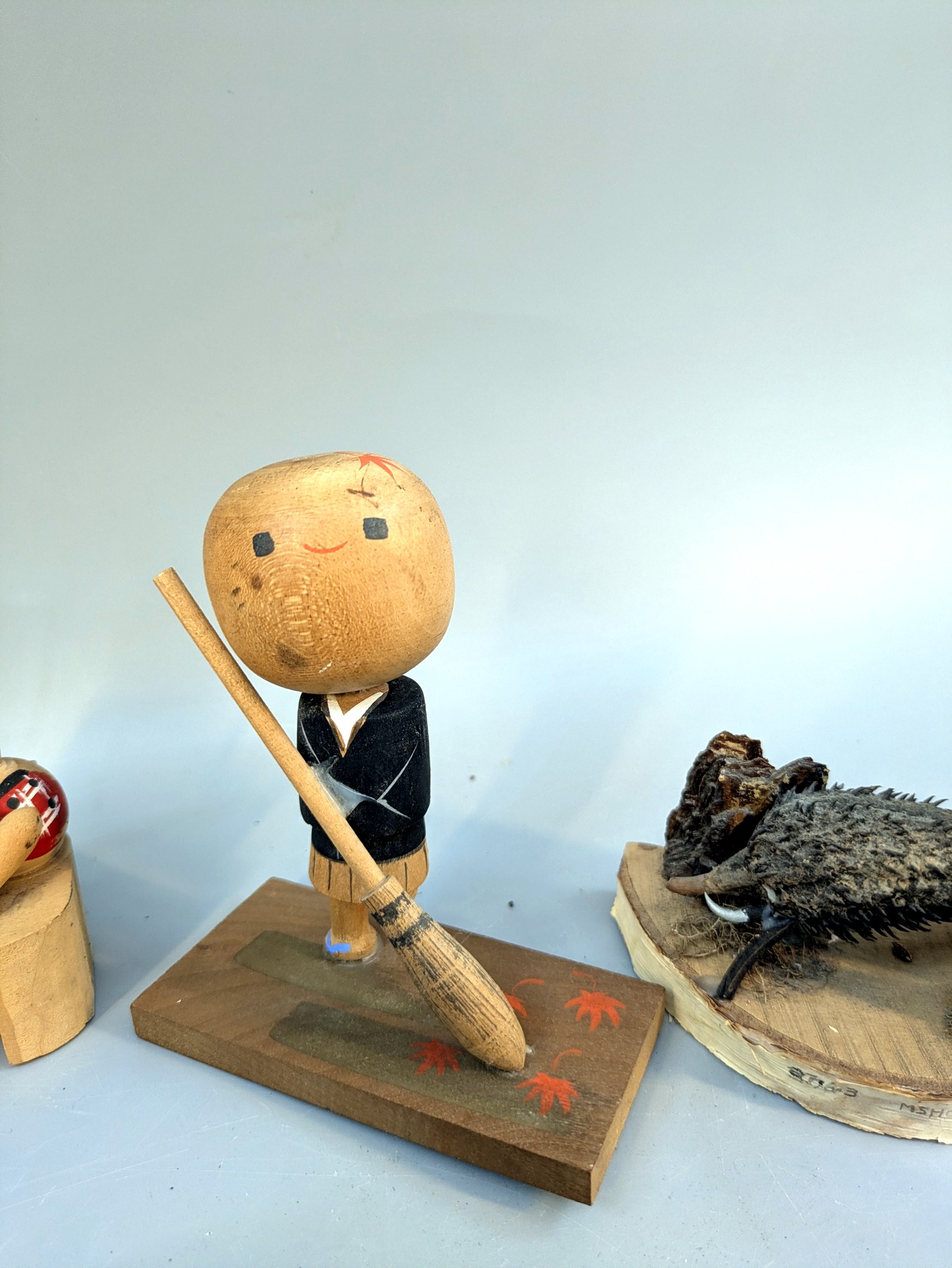 Small figure holding a broom